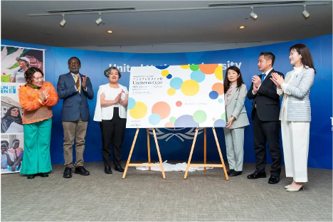 people clapping next to sign