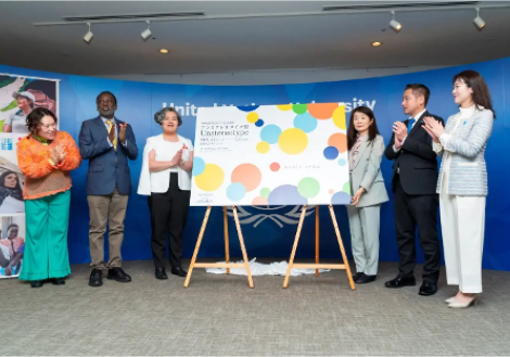 people clapping next to sign